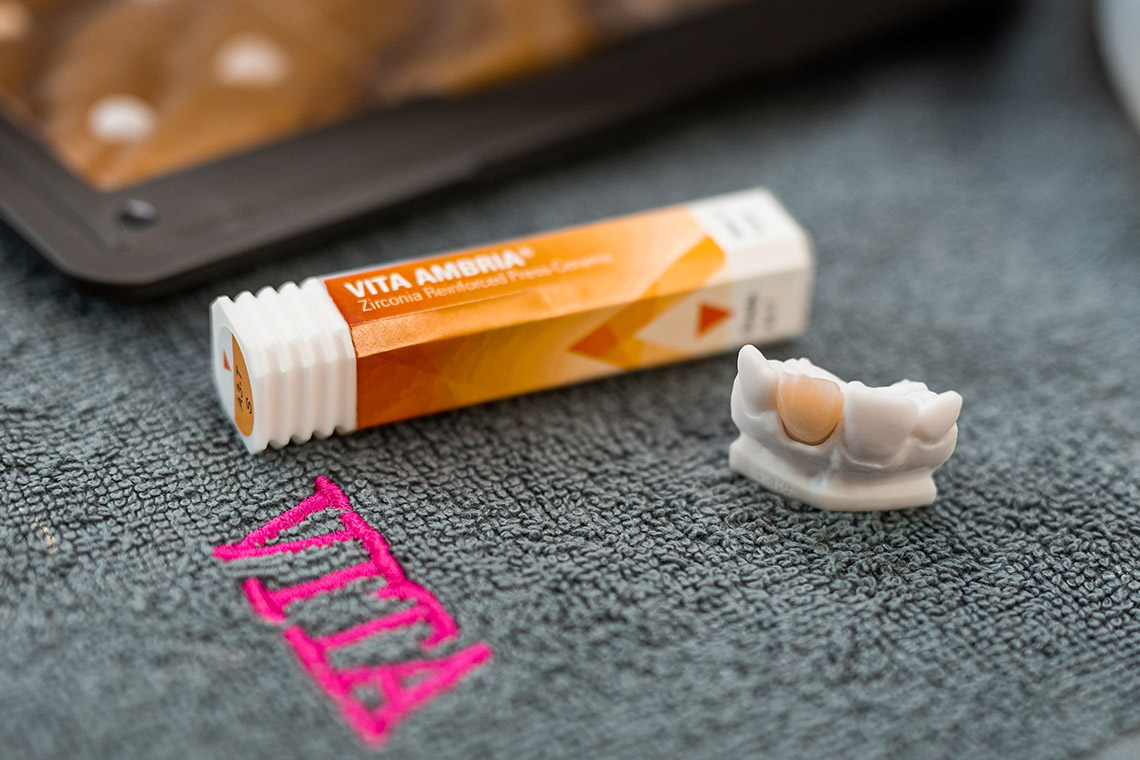 VITA AMBRIA Press Ceramic package and an anterior tooth crown on a model